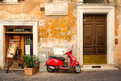 Типичная улица в Риме с самокатом на узкой улице