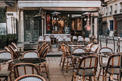 Вид на парижскую улицу из кафе со столиками